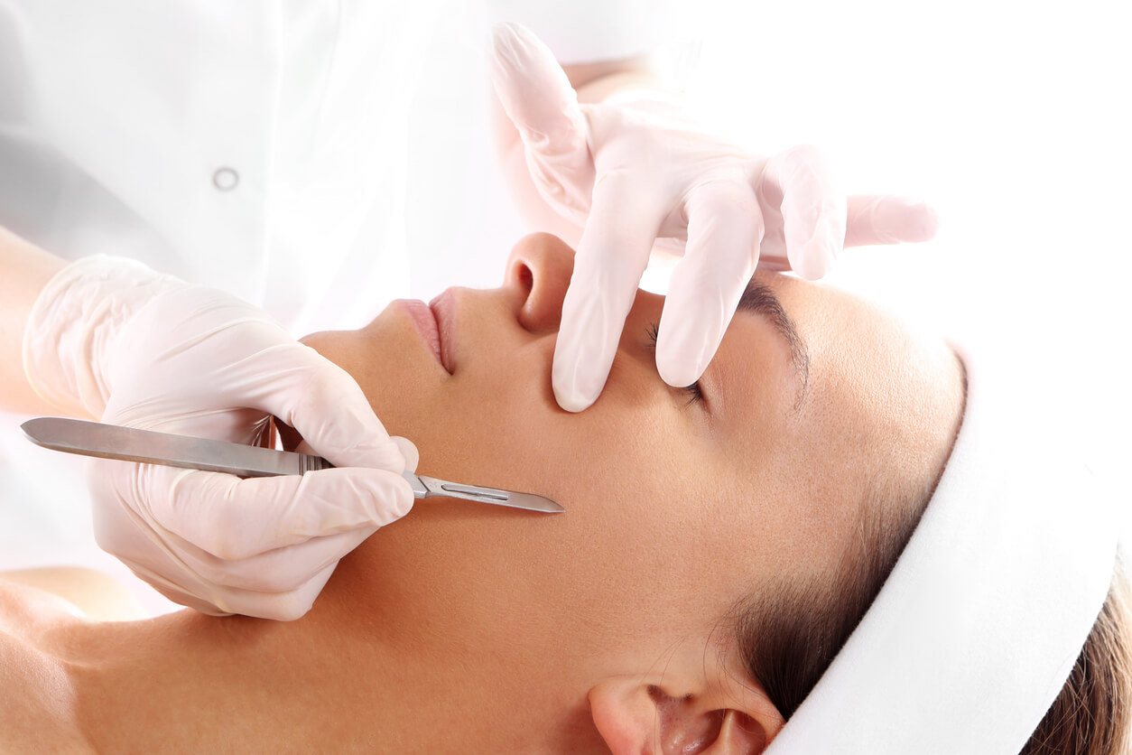 Adult woman getting dermaplaning on her face